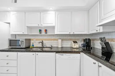 a white kitchen with white cabinets and a sink at 1BED Condo w/Pool View | 3rd Floor at Tides in Hollywood
