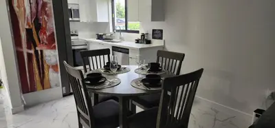 a table and chairs with cups and saucers on it in a kitchen at Welcome to Miami! in Miami