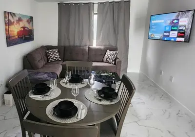 a living room with a table and a couch at Welcome to Miami! in Miami