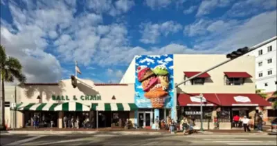 a city street with a building with a sandwich billboard at The Havana Nights Guesthouse - Private Stay with Free Parking in the Heart of Miami in Miami