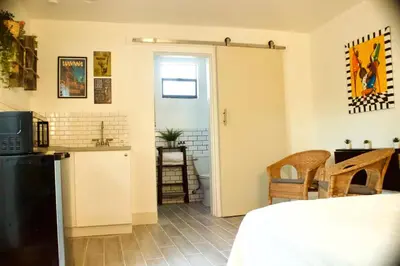 a room with a kitchen and a bed and a door at The Havana Nights Guesthouse - Private Stay with Free Parking in the Heart of Miami in Miami