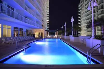 a swimming pool in the middle of a building at night at Newly Renovated 3BR Condo with Bay Views and Parking in Miami