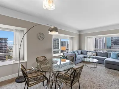 a living room with a table and chairs and a couch at Four Seasons Miami Luxury Two-Bedroom Suite in Brickell - Free Parking in Miami