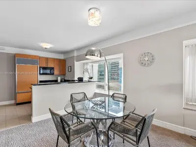 a dining room with a glass table and chairs at Four Seasons Miami Luxury Two-Bedroom Suite in Brickell - Free Parking in Miami