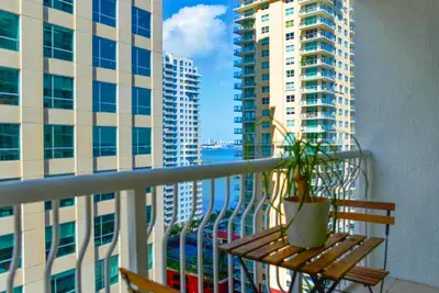 a balcony with a view of a city with tall buildings at Comfortable Brickell Studio - City View & Free Parking in Miami