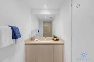 a bathroom with a sink and a mirror at Hollywood Oceanfront Apt in Hollywood