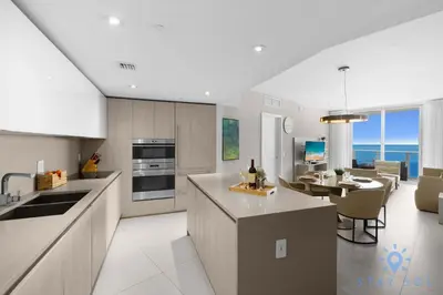 a kitchen and dining room with a view of the ocean at Hollywood Oceanfront Apt in Hollywood