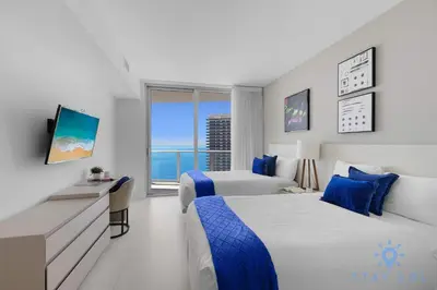 a hotel room with two beds and a television at Hollywood Oceanfront Apt in Hollywood