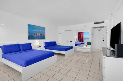a bedroom with two beds and a tv in it at 530 - Miami Beach Large studio Ocean View in Miami Beach