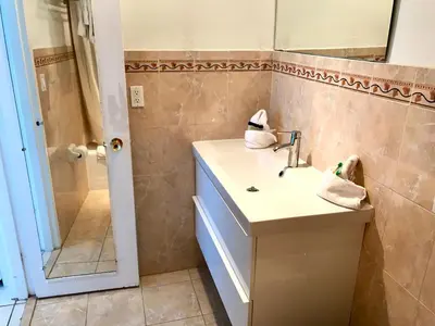 a bathroom with a sink and a shower at 530 - Miami Beach Large studio Ocean View in Miami Beach