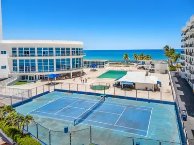 a tennis court with the ocean in the background at 530 - Miami Beach Large studio Ocean View in Miami Beach