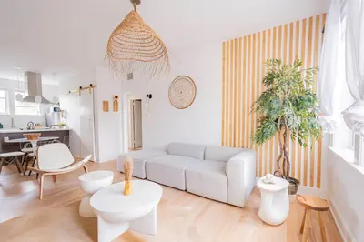 a living room with a couch and a table at Designer 2BR Condo, 5 Mins to Sand, Free Parking in Hollywood