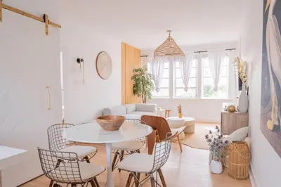 a white living room with a white table and chairs at Designer 2BR Condo, 5 Mins to Sand, Free Parking in Hollywood