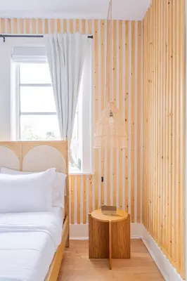 a bedroom with a bed and a table at Designer 2BR Condo, 5 Mins to Sand, Free Parking in Hollywood
