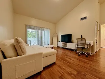 a living room with a white couch and a desk at 1B - 1B Apartment for 3 at Pembroke Pines in Pembroke Pines