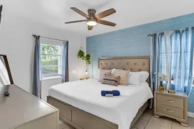 a bedroom with a large bed with a ceiling fan at 437 NE 107th · Pool Hot Tub Patio 5 Bedrooms 3 BathsParking in Miami Shores