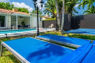 a group of blue ping pong tables in a yard at 437 NE 107th · Pool Hot Tub Patio 5 Bedrooms 3 BathsParking in Miami Shores