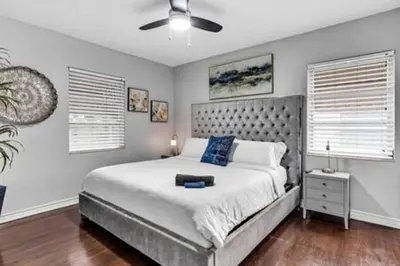 a bedroom with a bed and a ceiling fan at 427 NE 107th Studio · 6BR 3BA 7 Beds Pool Parking 2 Kitchen in Miami Shores