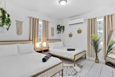 a living room with two beds and a couch at 1834 SW 27th Ave 2 · Vibrant Miami Getaway 2 Beds Near Beach Port in Miami