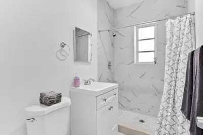 a white bathroom with a sink and a shower at 1834 SW 27th Ave 2 · Vibrant Miami Getaway 2 Beds Near Beach Port in Miami