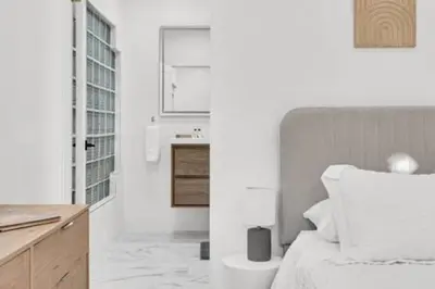 a white bedroom with a bed and a sink at 1720 Wa Kee 2A · Luxurious 4BR 3BA Retreat in Coconut Grove w Pool in Miami
