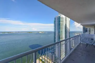 a balcony of a building with a view of the ocean at Brickell 3802 · Picturesque Bay Views Pool Sleeps 8 Gym in Miami