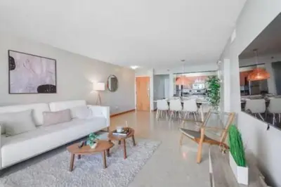 a living room with a white couch and a table at Brickell 3802 · Picturesque Bay Views Pool Sleeps 8 Gym in Miami