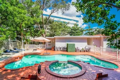 a swimming pool in the middle of a yard at 2710 · Heated Pool 7 Beds 5 Baths Sleep 15 Park 4 Car in Miami
