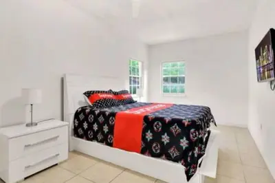 a white bedroom with a bed and a white dresser at 2710 · Heated Pool 7 Beds 5 Baths Sleep 15 Park 4 Car in Miami