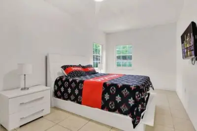 a white bedroom with a bed and a white dresser at 2710 · Heated Pool 7 Beds 5 Baths Sleep 15 Park 4 Car in Miami