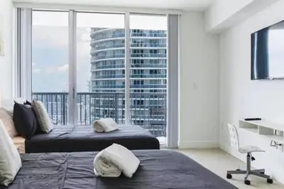 a bedroom with two beds and a large window at Waterfront 1BR w Bay ViewsBalcony Full Kitchen in Miami