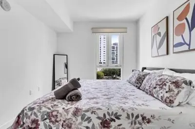 a bedroom with a large bed with a flower pattern at Modern 1BR Apt In Edgewater Free Parking in Miami