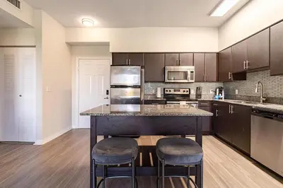 a kitchen with a large island with two bar stools at Landing Spectacular 1BD Gym Clubhouse in Miramar