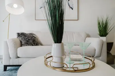 a living room with a table with a vase and glasses at KOOSH - Boutique Aparthotel in Fort Lauderdale