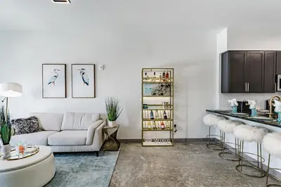 a living room with a couch and a table at KOOSH - Boutique Aparthotel in Fort Lauderdale