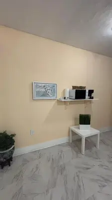 a room with a table and a microwave on a wall at The Studio 6 Little Havana Walk to Marlins Stadium in Miami