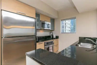 a kitchen with a stainless steel refrigerator and a sink at Marenas Beach Resort Private Luxury Suites in Miami Beach