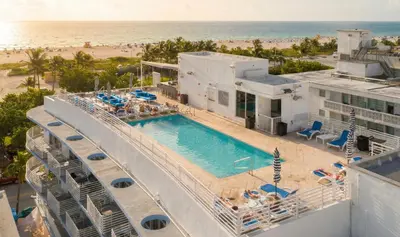 an aerial view of a resort with a swimming pool and the beach at Ocean Drive Apt with Balcony & Rooftop Pool in Miami Beach