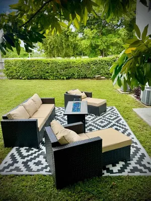 a patio with couches and tables on a rug at Miami Vibes in Miami
