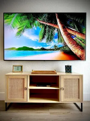 a tv hanging on a wall with a tv stand at Miami Vibes in Miami