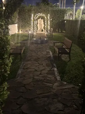 a park with two benches and a statue with lights at Young Mansion Steps To The Beach in Hollywood