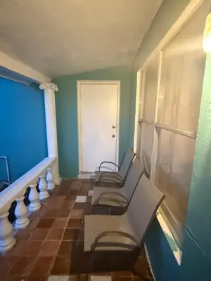 a room with three benches and a white door at The Luxe Loft in Fort Lauderdale