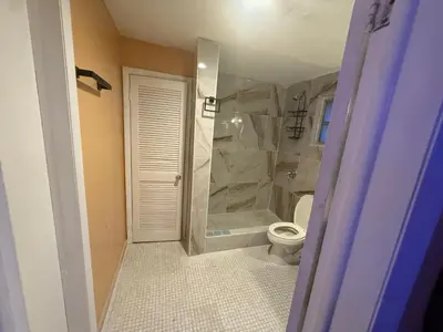 a bathroom with a toilet and a walk in shower at The Luxe Loft in Fort Lauderdale