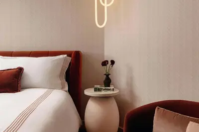 a bedroom with a bed and a vase with flowers at UNFRAMED Miami Beach, Autograph Collection in Miami Beach