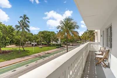 a balcony with chairs and a view of a park at Spacious APT on South Beach Roof Top Pool & Bar in Miami Beach
