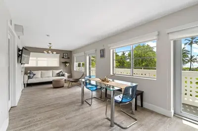 a living room with a table and chairs and a couch at Spacious APT on South Beach Roof Top Pool & Bar in Miami Beach