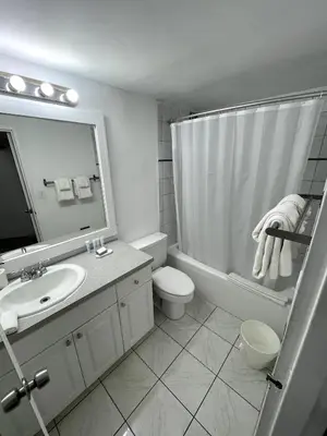 a bathroom with a sink and a shower and a toilet at Shine Suites Balcony Studio 7 in Miami Beach