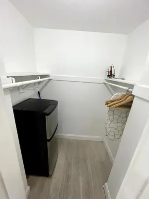 a small white kitchen with a black dishwasher at Shine Suites Balcony Studio 7 in Miami Beach