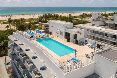 an aerial view of a resort with a swimming pool and the beach at Modern Studio in the Heart of South Beach in Miami Beach