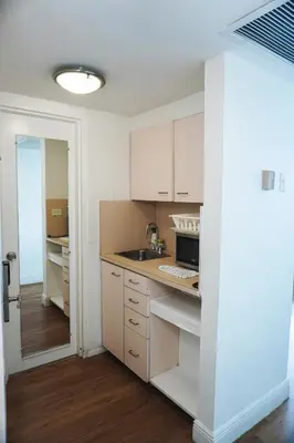 a kitchen with white cabinets and a sink at Shine Suites Studio 11 in Miami Beach